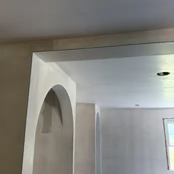 smooth plaster finish around an arched doorway