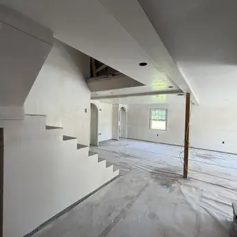 plastered staircase in an open-plan renovation
