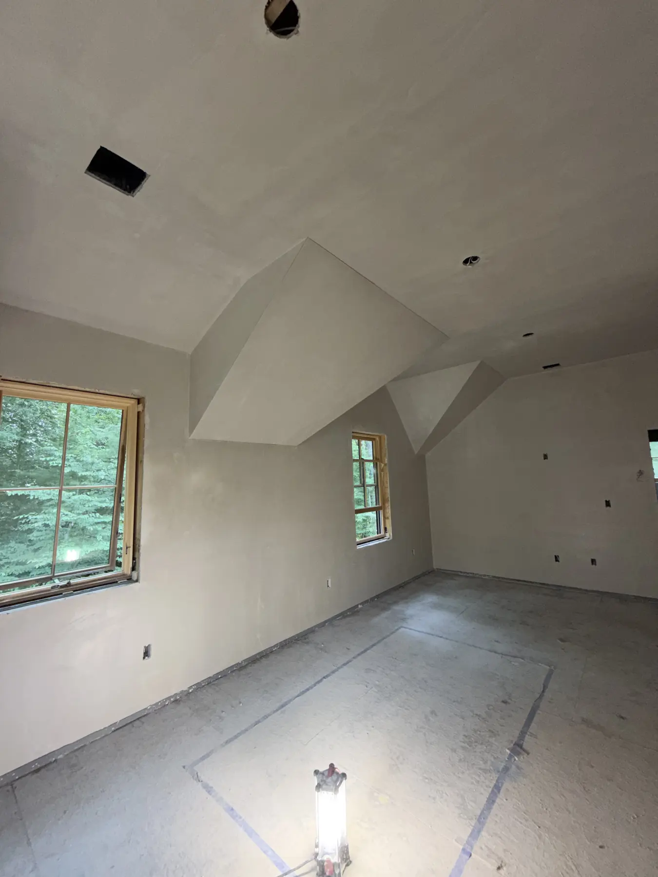 Plastered dormer ceiling and walls with two windows